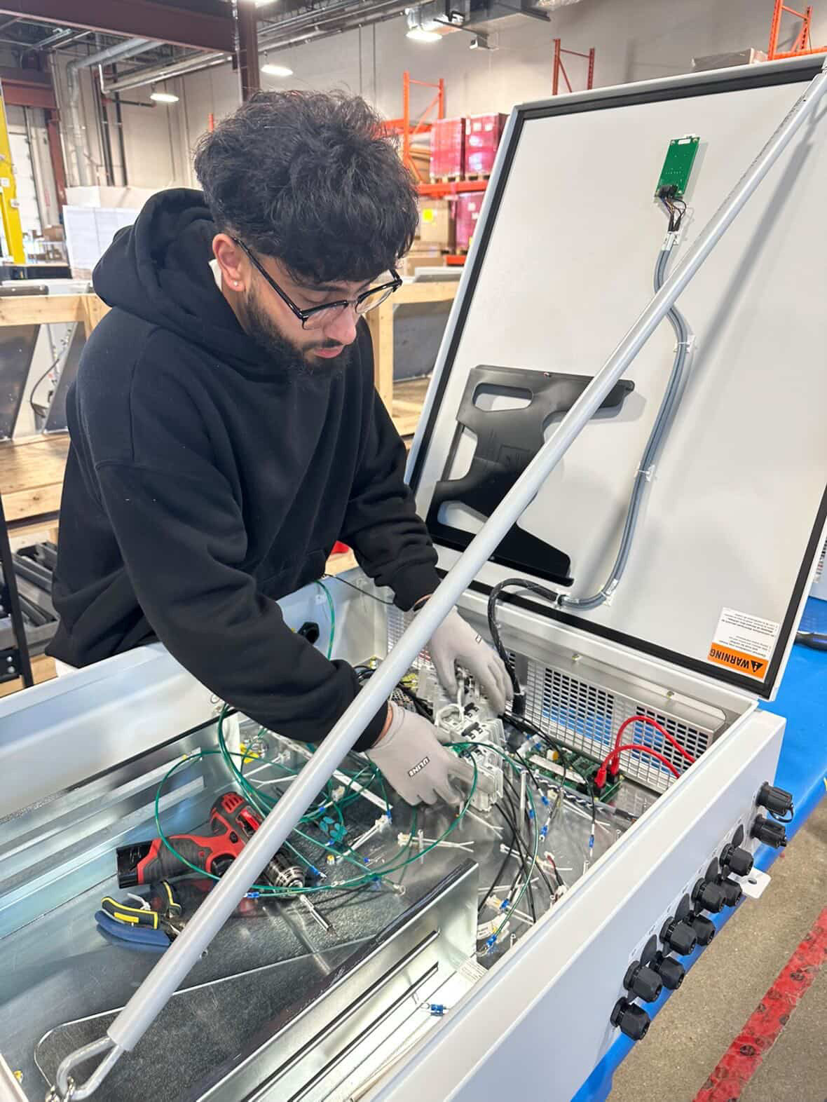 Farmaan working on a control panel